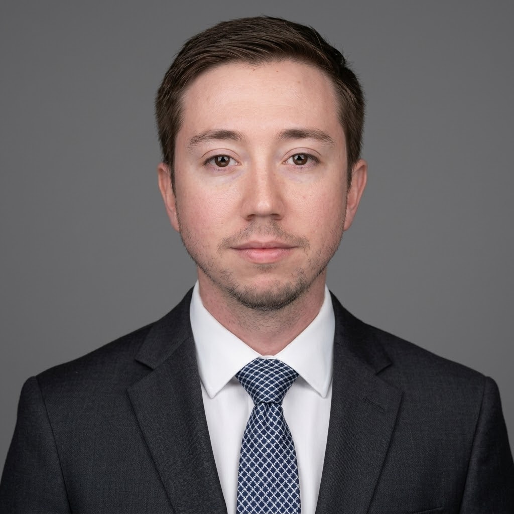 Xavier Jenkins wearing a charcoal suit and patterned tie